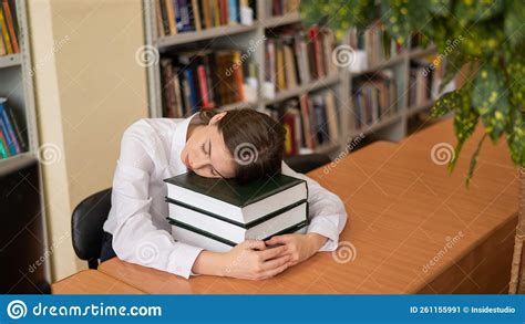 Young Woman Sleeping On Textbooks In A Public Library Stock Image