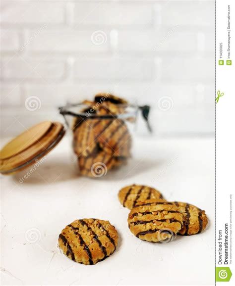 cookies polished with chocolate and peanut pieces in a glass jar with a