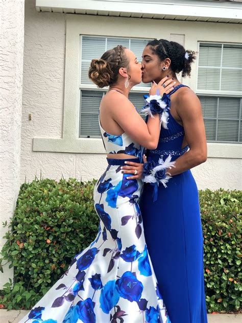 lesbian couple shares a kiss in public as they step out