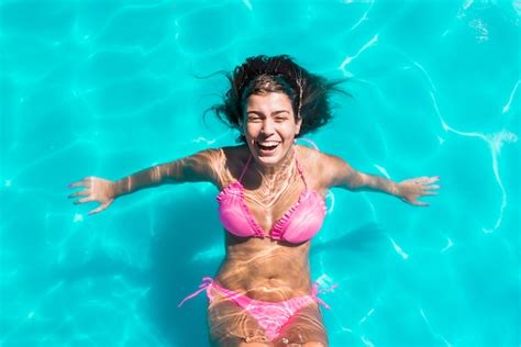 Premium Photo Young Smiling Woman Swimming In Pool