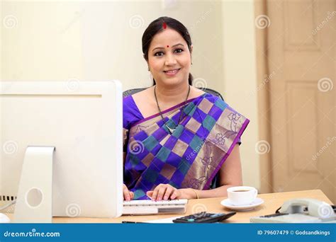 happy traditional indian business woman  office desk stock image