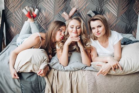 Free Photo Three Caucasian Female Friends In Pyjamas Have A Lot Of