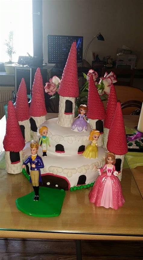 cake decorated  princess figurines   table
