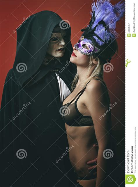 fashion woman in lingerie wearing venetian mask stock