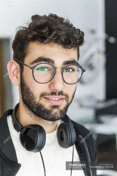 Portrait Of Smiling Man With Glasses And Headphones