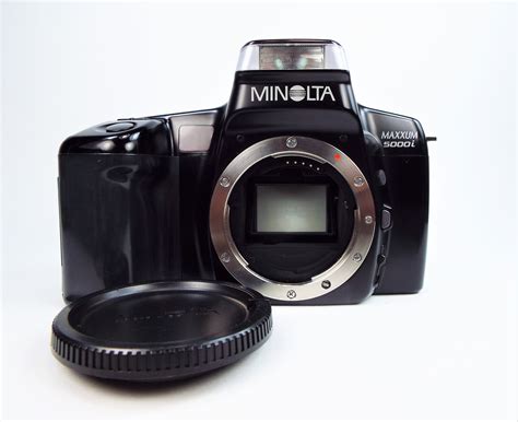 minolta maxxum  mm slr film camera  minolta body cap instruction manual  papers