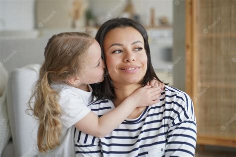 Premium Photo Loving Adopted Daughter Hugs Kissing Foster Mom Happy