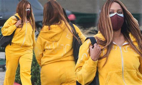 tyra banks slips her famous curves into a bright yellow tracksuit at