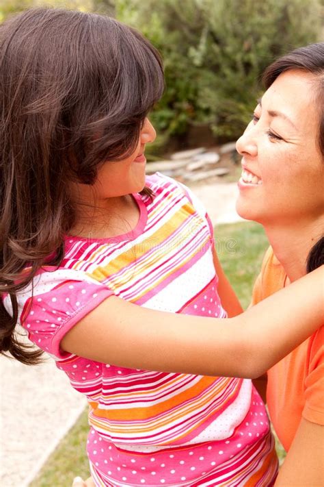 loving asain mother and her daughter smiling stock image
