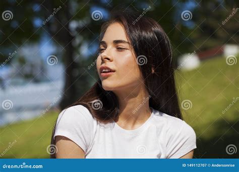 Beautiful Brunette Woman Posing Against Summer Park Bright Sunny