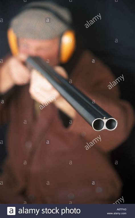 man aiming  double barrel shotgun stock photo alamy