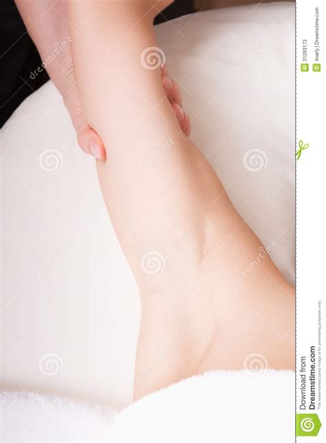 therapist doing massage on the back of woman s arm stock