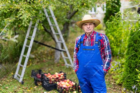 Premium Photo Grandpa Farmer Is Standing With His Hands In The