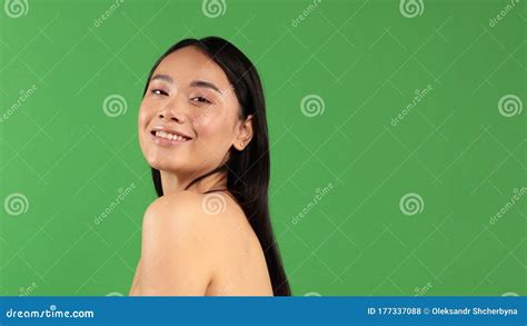 Women`s Beauty Portrait Of Young Smiling Asian Woman Isolated On Green