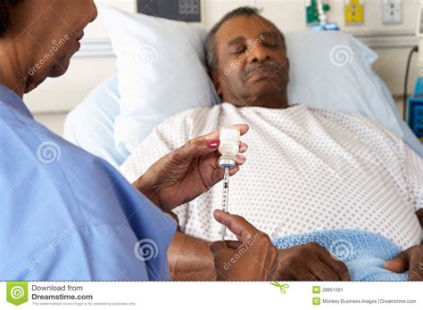 nurse preparing to give senior male patient injection