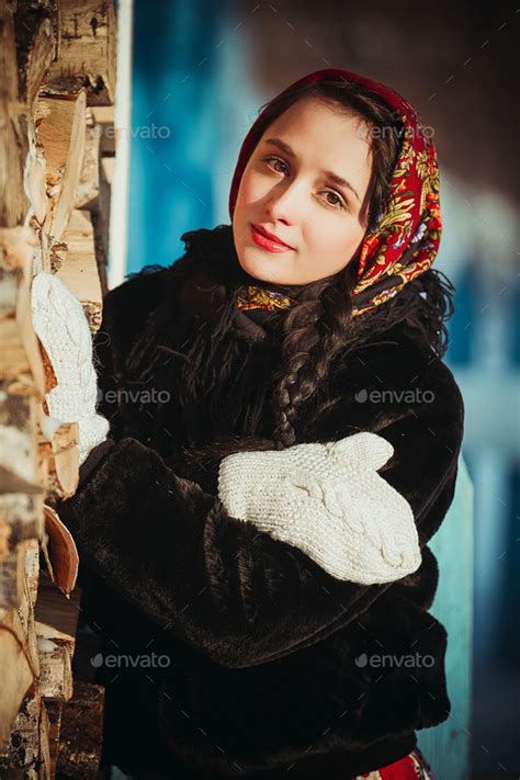 russian woman beautiful in the dress and the fur coat in the winter