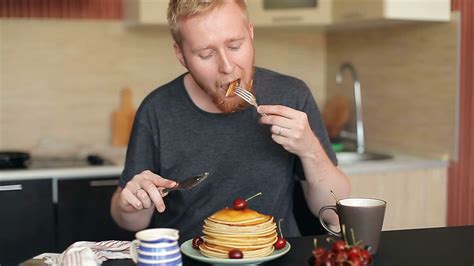 man eat pancakes drink tea  kitchen stock footage sbv  storyblocks