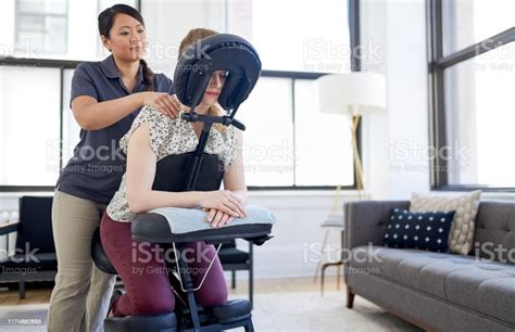Chinese Woman Massage Therapist Giving A Neck And Back Pressure