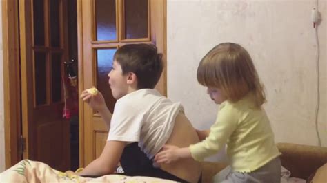 little sister massage for brother when brother is watching tv