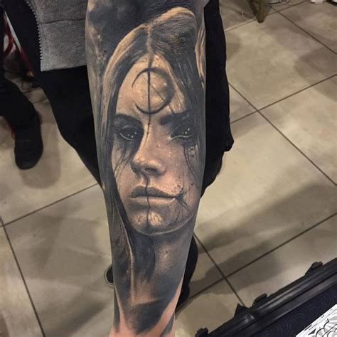 creepy looking portrait style black ink leg tattoo of demonic woman