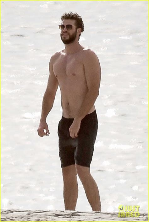 Liam Hemsworth Goes Shirtless On The Beach Where He Met