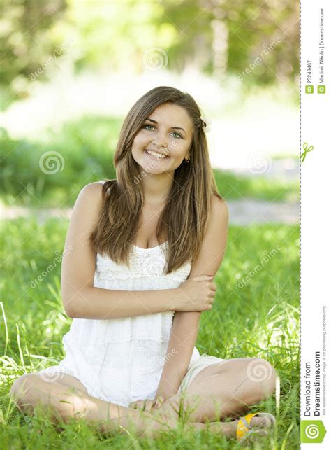 Beautiful Teen Girl In The Park At Green Grass Stock