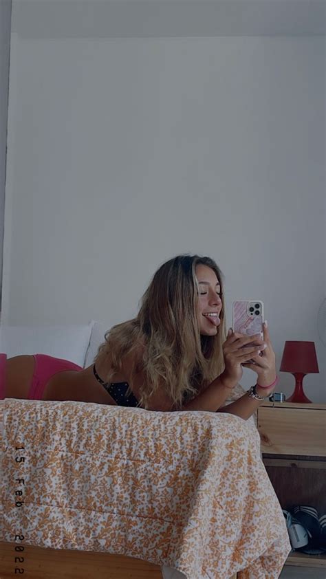 a woman taking a selfie in her bedroom
