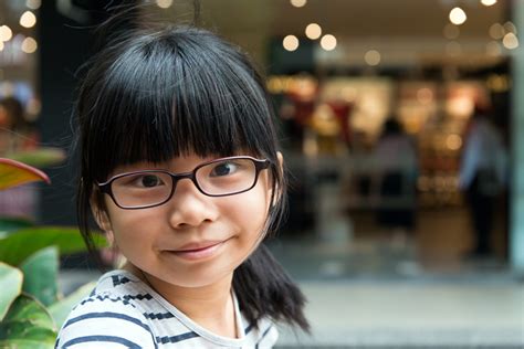 cute asian chinese girl with glasses in park pcn6s3s salud y vida