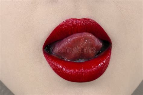 sensual mouth with red lipstick white teeth and licking lips with