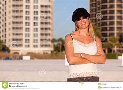 attractive middle aged blond woman at the beach stock