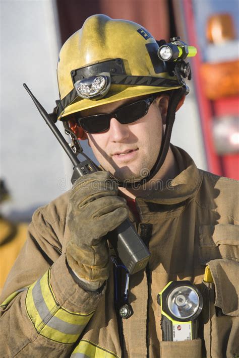 portrait of a firefighter talking on radio royalty free
