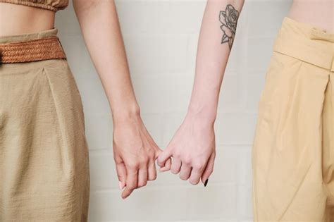 Premium Photo Lesbians Holding Finger Together