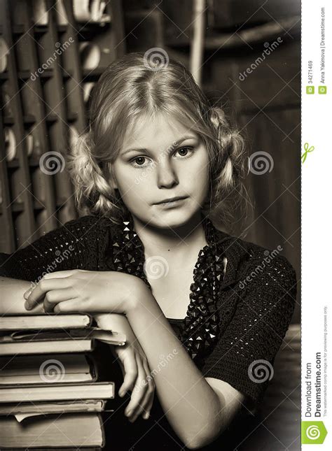 teen girl in retro style with a stack of books royalty