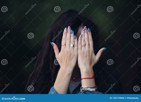 girl  gorgeous dark long hair hiding face  arms stock photo image  head hide