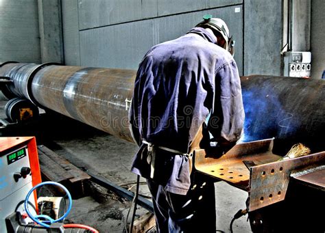 metalwork construction of large tubes with workers working