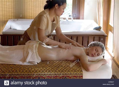 A Blonde Female Lying On Her Stomach On A Massage Table
