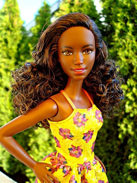 barbie doll wearing  yellow dress  flowers   chest  long hair