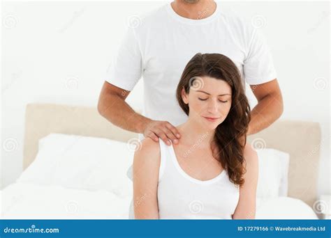 attentive man doing a back massage to his wife royalty free stock image