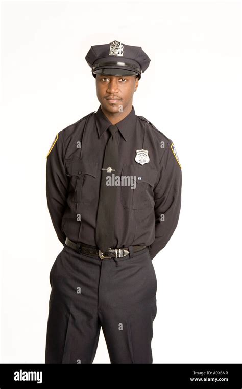 young black american police officer  uniform standing   hands    stock