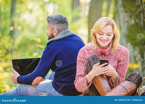 modern life happy loving couple relaxing  park  mobile gadgets stock photo image