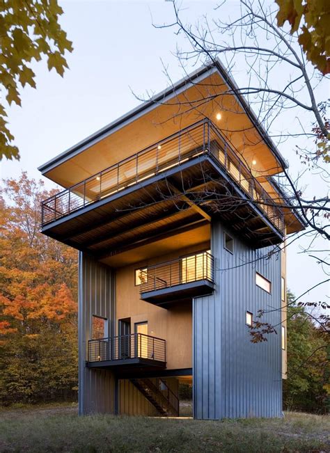 storey tall house reaches   forest    lake modern house designs