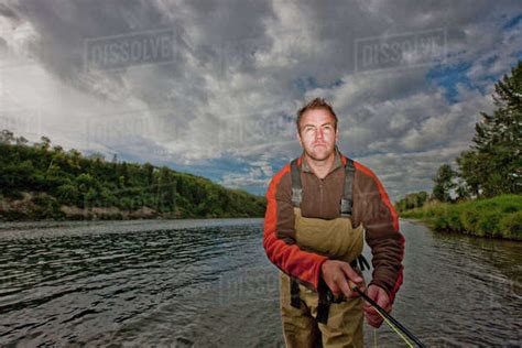 fly fisherman stock photo dissolve