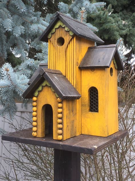 yellow bird house sitting  top   wooden post