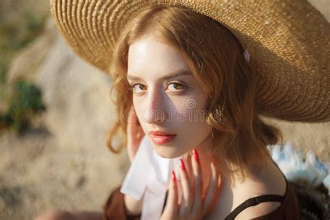Portrait Of Sweet Blonde Girl In Straw Hat Posing On A Background Of