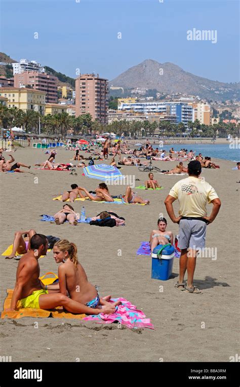 sunbathing  beach  mediterranean sea   city  malaga costa del sol spain stock photo