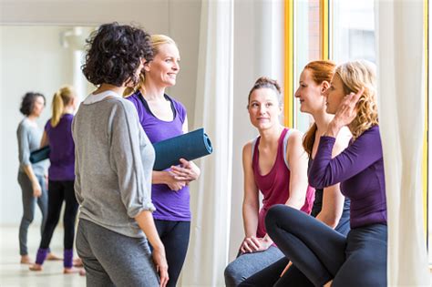 group of women during yoga class break at health club