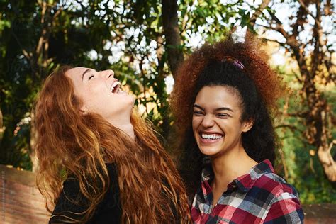 girls laughing out loud in park by stocksy contributor guille