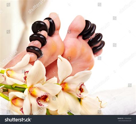 Woman Receiving Hot Stone Massage On Feet Isolated Stock