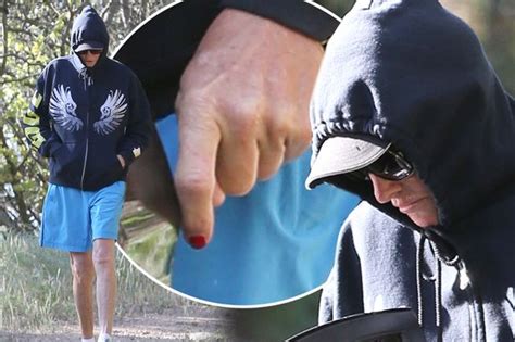 Bruce Jenner Shows Off Red Painted Nails As Date Of