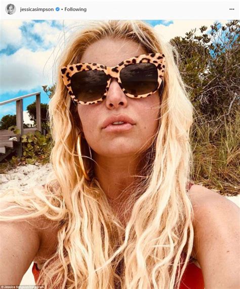 jessica simpson models racy red bikini as she has a ball